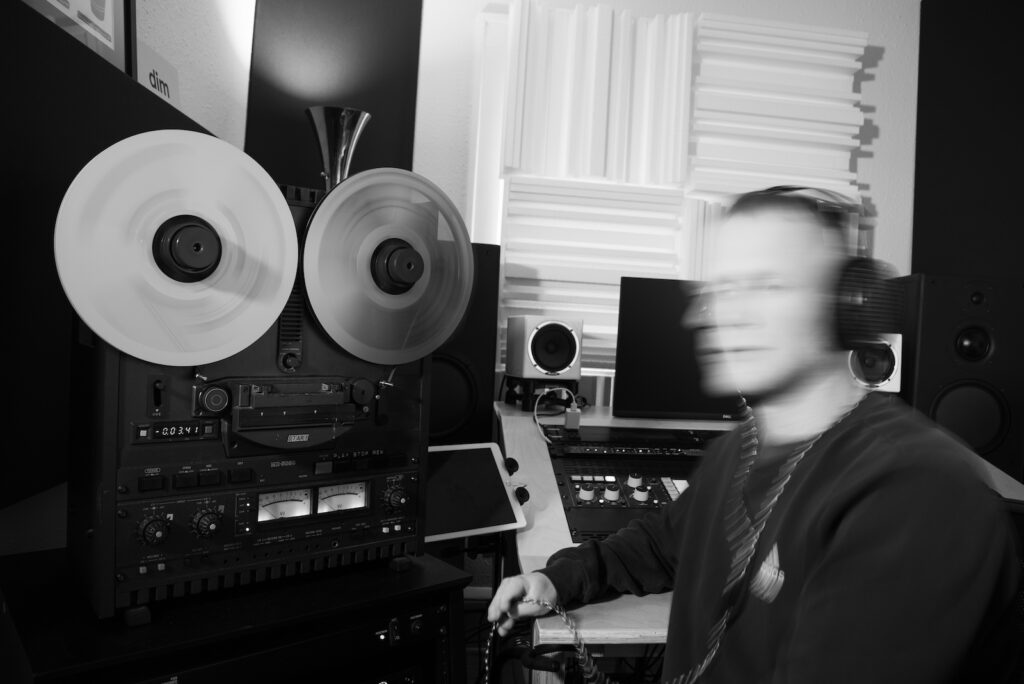 Minneapolis mastering engineer Alec Ness standing on a path way surrounded by trees