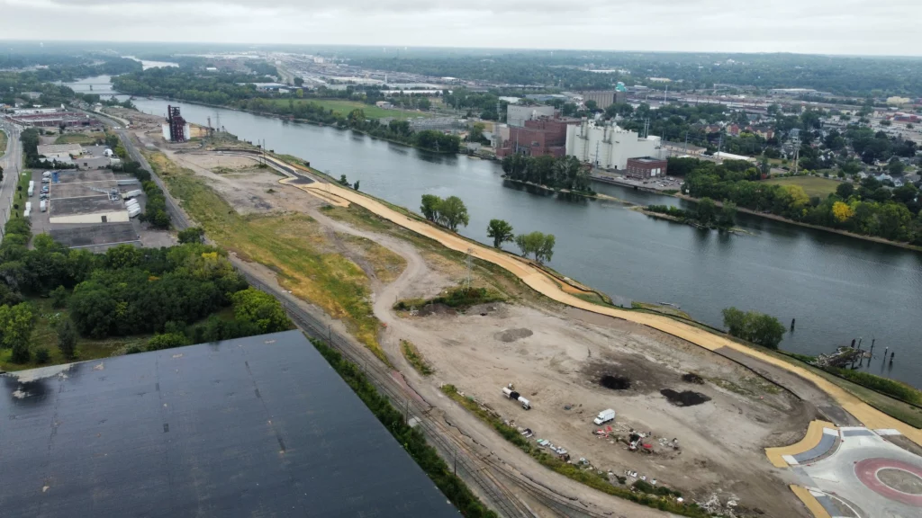 North-facing aerial view of Minneapolis' Upper Harbor Terminal development site along the Mississippi River.